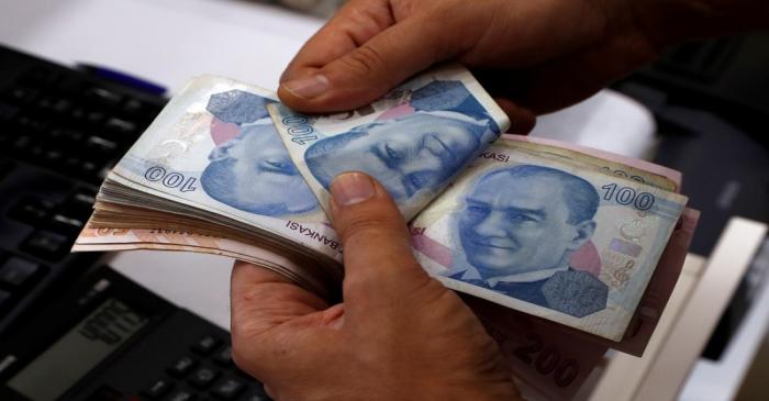 FILE PHOTO: A money changer counts Turkish lira banknotes at a currency exchange office in