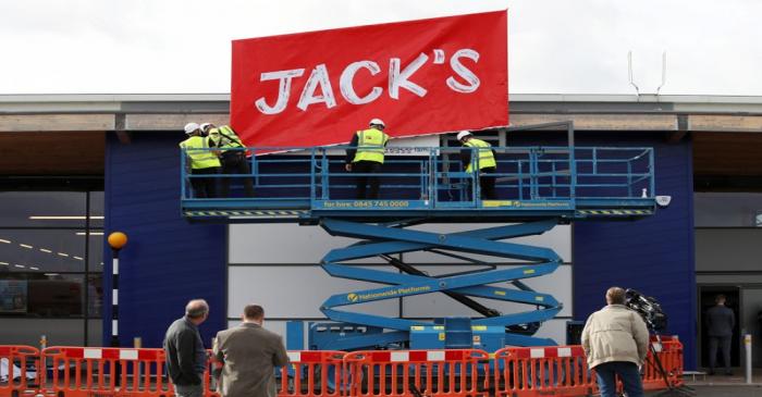 Workers unveil the branding at Tesco's new discount supermarket Jack's, in Chatteris
