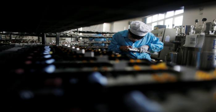 Labourer works inside an electronics factory in Qingdao
