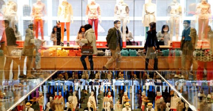 FILE PHOTO: Shoppers look at merchandise at Fast Retailing's new flagship Uniqlo store at