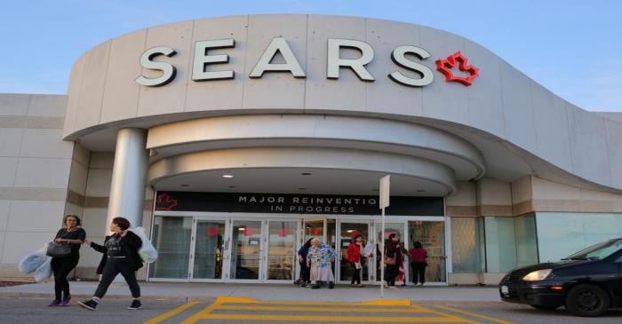 Shoppers leave a Sears store on the first day of liquidation sales in Mississauga