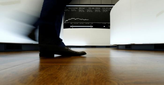 A trader walks past the German DAX Index board on the trading floor at the Frankfurt stock