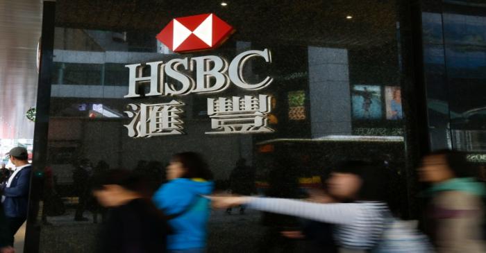 People walk past a major branch of HSBC at the financial Central district in Hong Kong