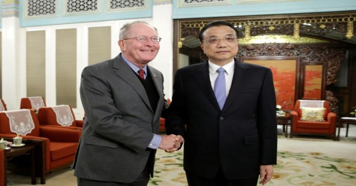 China's Premier Li Keqiang shakes hands with Tennessee Senator Lamar Alexander during a meeting