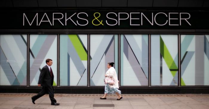 FILE PHOTO: File photo of pedestrians walking past an M&S shop in northwest London