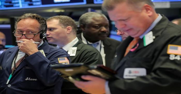 Traders work on the floor of the NYSE in New York