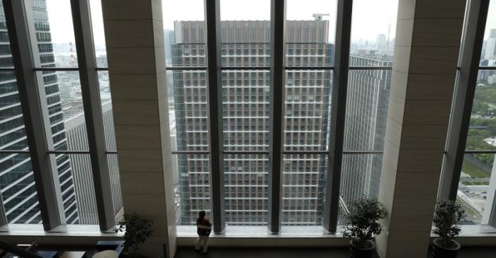 FILE PHOTO: A woman watches outside at an office building in Tokyo