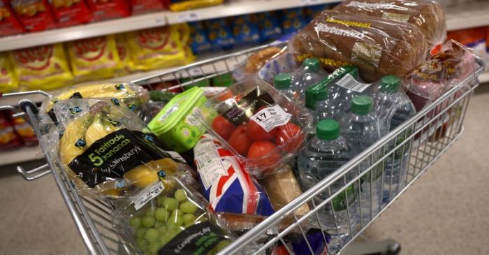 A shopper pushes a trolley in a supermarket in London
