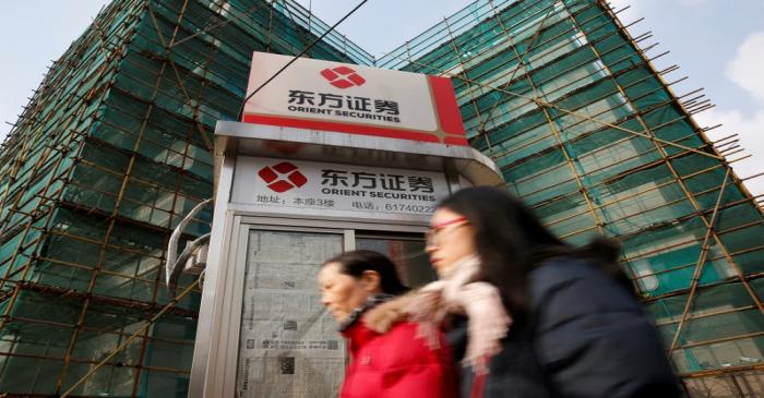 FILE PHOTO: Logos of Orient Securities are seen near a branch of the company in Shanghai