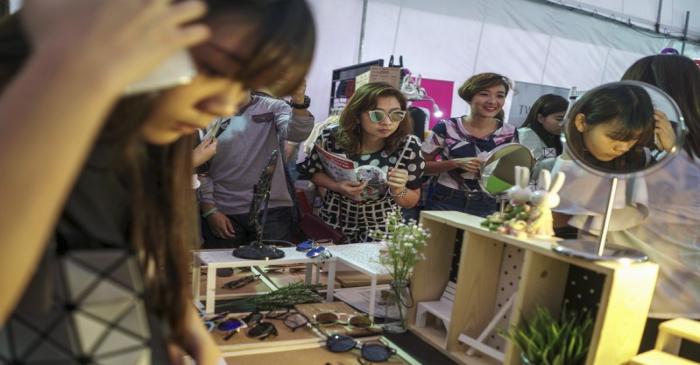File photo of customers trying on glasses at a shopping centre in Bangkok