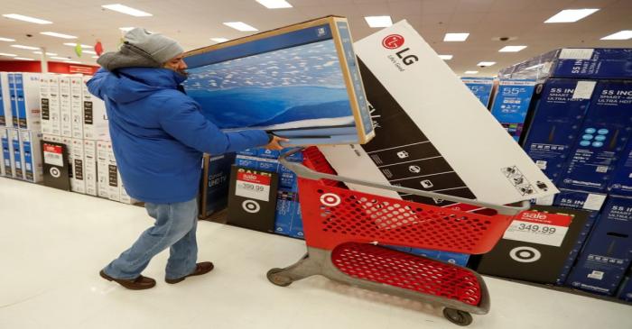 FILE PHOTO: Customer loads his shopping cart during the Black Friday sales event on