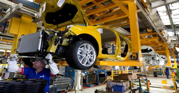 Employees of French carmaker Renault work on the Clio RS assembly line at Renault factory in