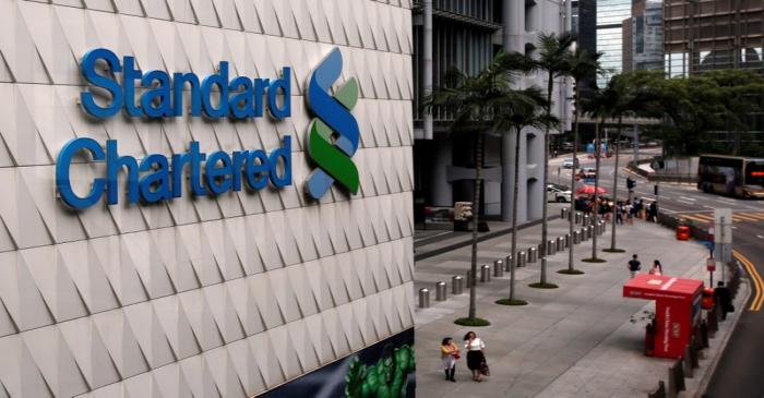 People walk outside the main branch of Standard Chartered in Hong Kong