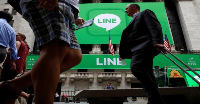 A banner for Japanese messaging app operator Line Corp. covers the facade of the New York Stock