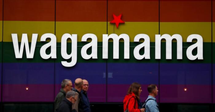 FILE PHOTO: People walk past a branch of restaurant chain Wagamama in Manchester
