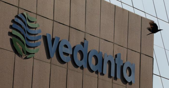 FILE PHOTO: A bird flies past the logo of Vedanta installed on the facade of its headquarters