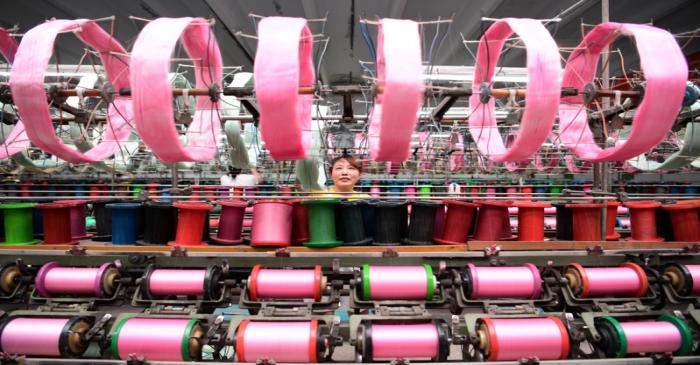 An employee works at a silk factory in Nantong
