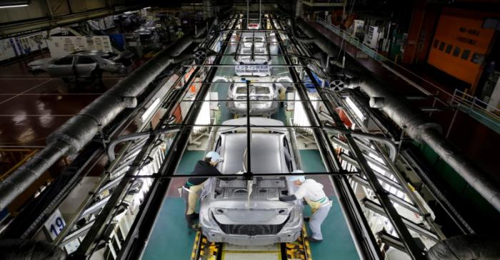 FILE PHOTO - Employees work on an assembly line of the Toyota Motor Corp's Prius hybrid car at