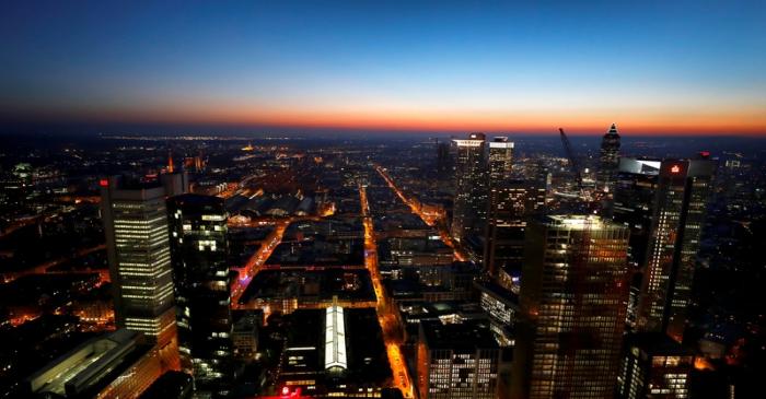 FILE PHOTO: The sun sets behind the financial district early evening in Frankfurt