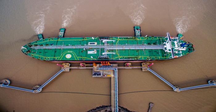 FILE PHOTO - Oil tanker unloads crude oil at a crude oil terminal in Zhoushan