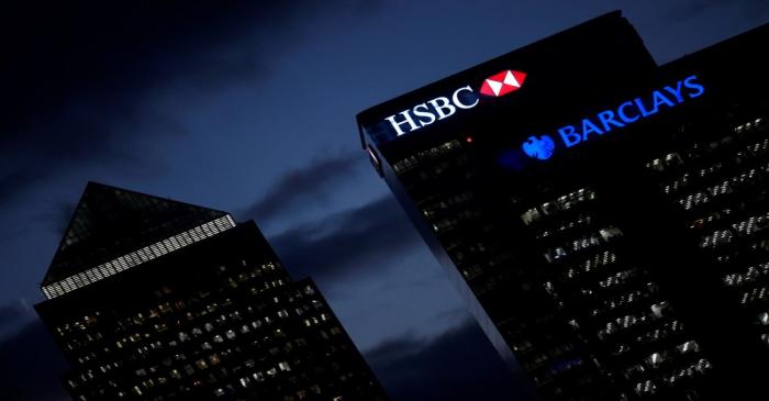 FILE PHOTO: The HSBC and Barclays buildings at dusk in the Canary Wharf financial district of