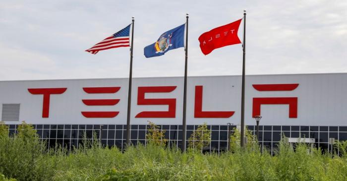 FILE PHOTO: Flags fly over the Tesla Inc. Gigafactory 2, which is also known as RiverBend, a