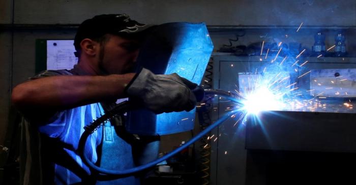 A worker welds in a factory in Gravellona Lomellina