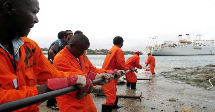 FILE PHOTO: Contractors lay TEAMS fiber optic cable from the ship Niwa on the Fort Jesus