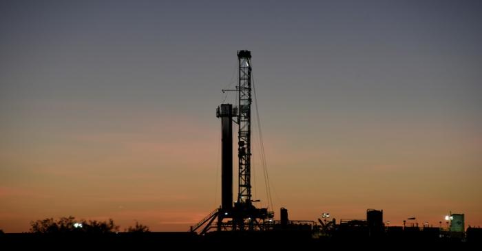 A horizontal drilling rig on a lease owned by Parsley Energy operates at sunrise in the Permian