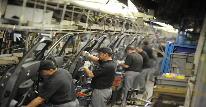 Nissan technicians prepare doors for the Qashqai car at the company's plant in Sunderland
