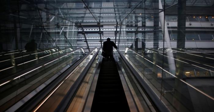 A man rides an escalator at a commercial building in Tokyo
