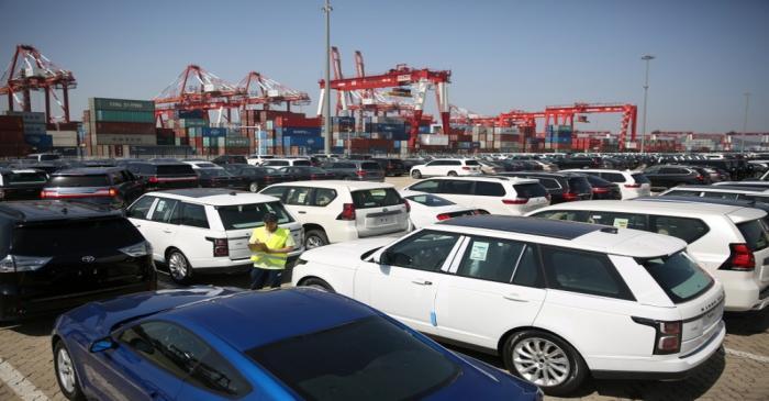 Worker inspects imported cars at a port in Qingdao