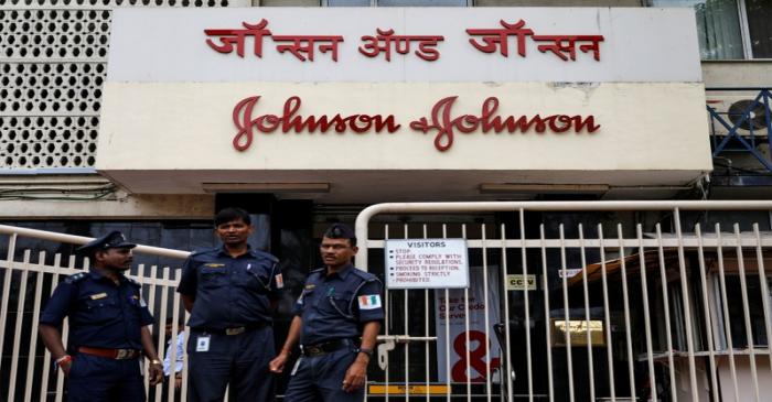 Security guards stand outside the office of Johnson & Johnson in Mumbai