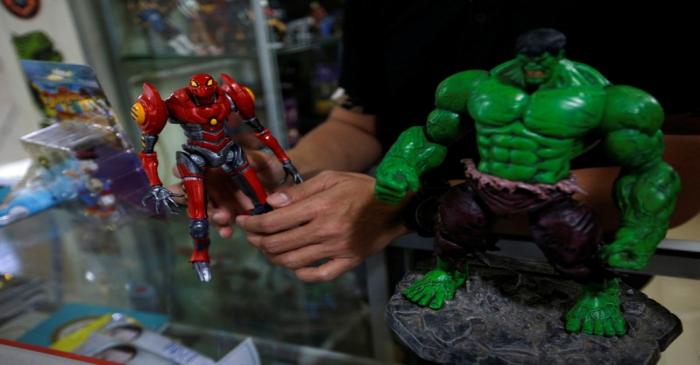 Andy Kurniawan, who is the owner of an action figure store, shows action figures at his store