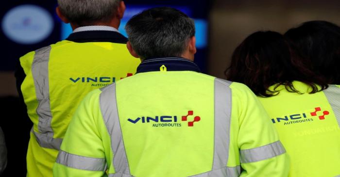 The Vinci logo is seen on jackets during a visit a a mobile factory installed to produce tons