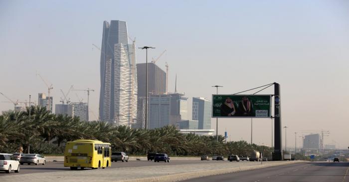 Cars drive past the King Abdullah Financial District in Riyadh