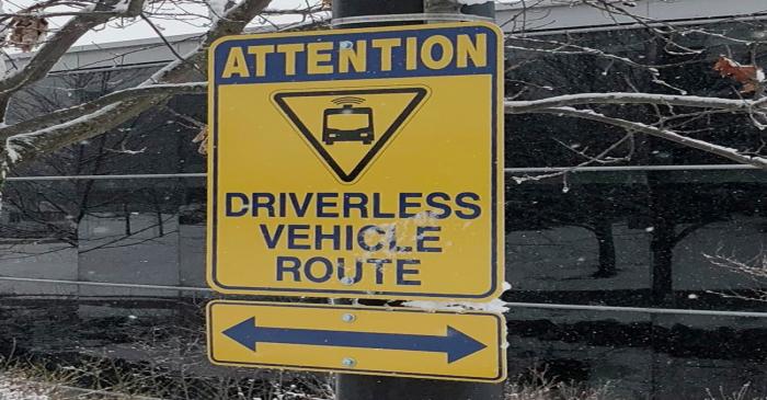 A sign marks part of a route used to test a driverless electric shuttle at the University of
