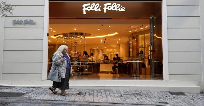 A woman walks past a Folli Follie store in central Athens