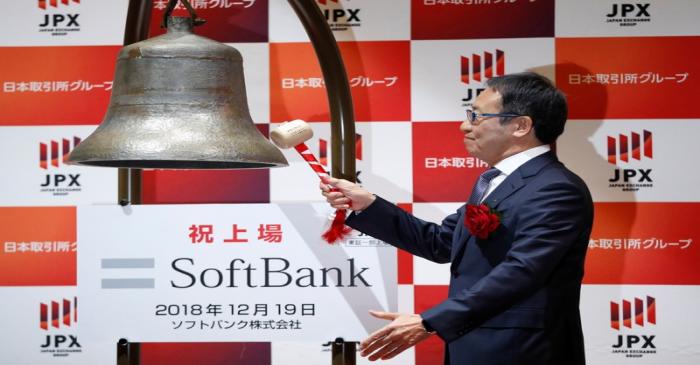 SoftBank Corp. President and CEO Ken Miyauchi rings a bell during a ceremony to mark the