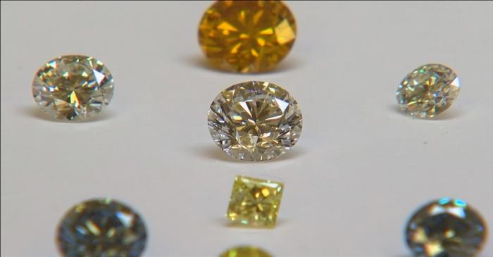 FILE PHOTO: A still image from video shows coloured synthetic diamonds on display at De Beers'