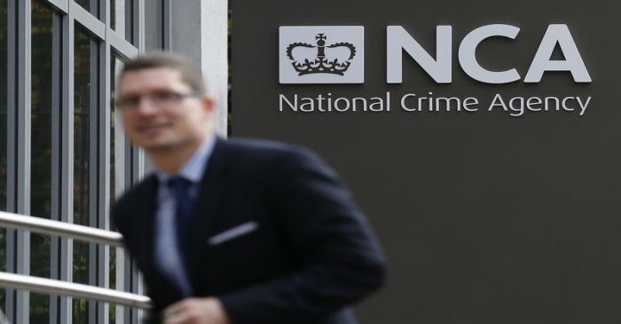 A man walks past the National Crime Agency headquarters in London