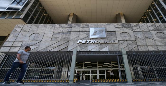FILE PHOTO: A man walks in front of the Brazil's state-run Petrobras oil company headquarters