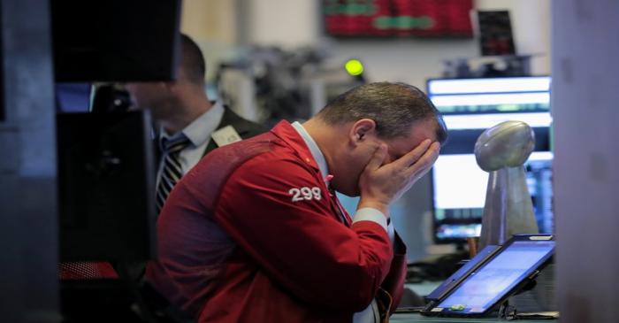 FILE PHOTO: Traders work on the floor of the NYSE in New York