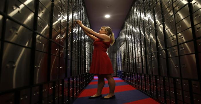A member of Metro Bank's staff poses for a photograph in the vault of their new branch in