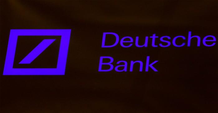 FILE PHOTO: A Deutsche Bank sign is seen on the floor of the New York Stock Exchange