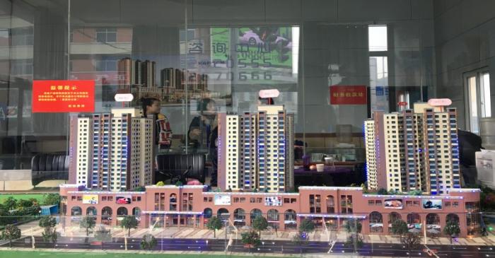 Model showing a residential and commercial compound is seen at a real estate showroom in Yanan