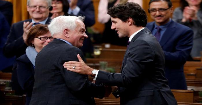 FILE PHOTO: Canada's PM Trudeau shakes hands with former Immigration Minister John McCallum in