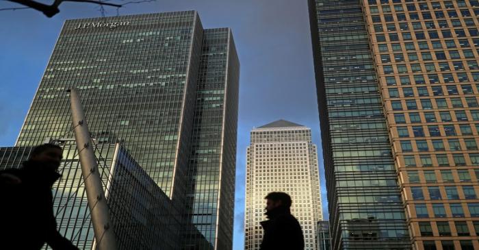 FILE PHOTO: People walk through the Canary Wharf financial district of London