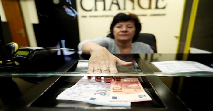 FILE PHOTO: Woman exchanges forints for euros at currency exchange shop in Esztergom