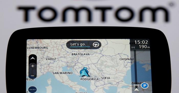 FILE PHOTO: TomTom navigation are seen in front of TomTom displayed logo in this illustration